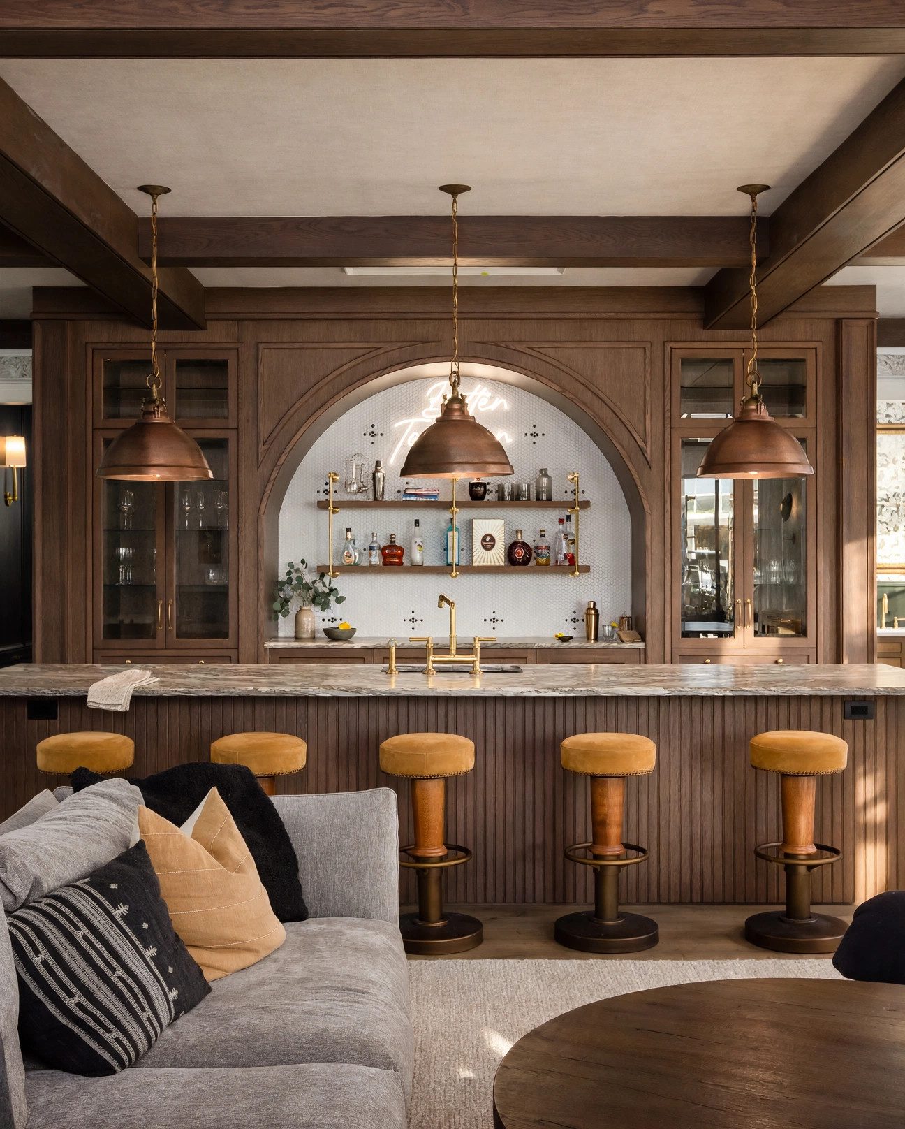 Custom walnut lounge and bar with brass lighting and upholstered seating