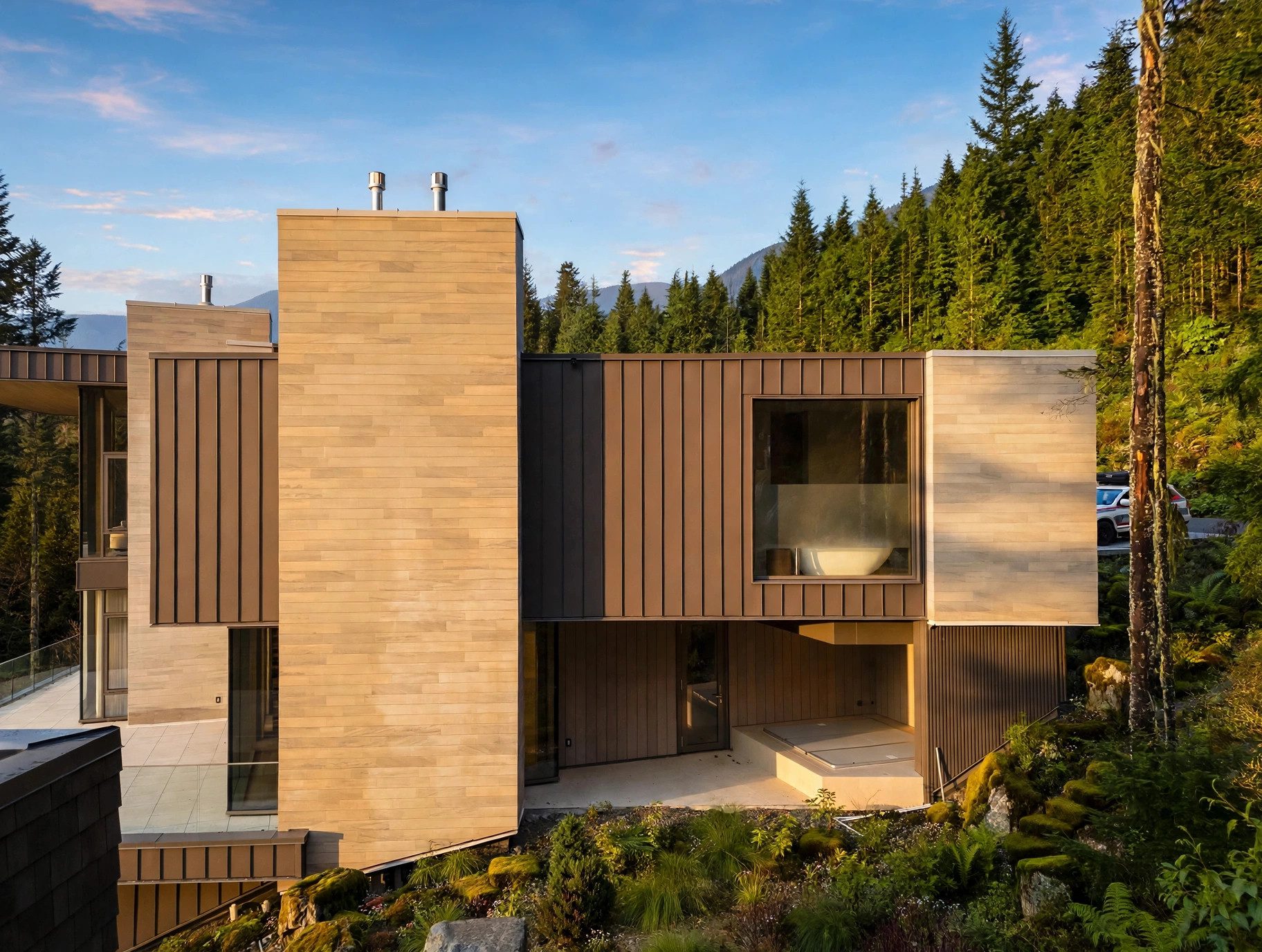 Rear elevation of a contemporary mountain residence with completed evergreen landscaping